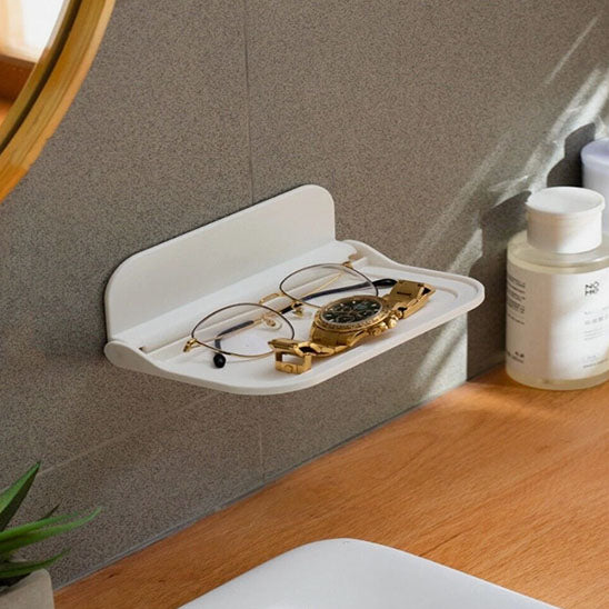 Étagère salle de bain murale pliable avec un design moderne et épuré.