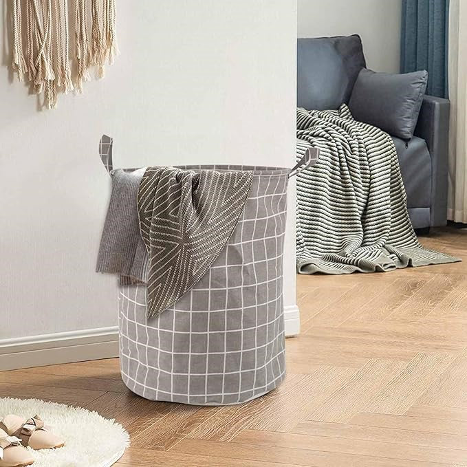Panier à linge pliable gris en coton, idéal pour la buanderie.