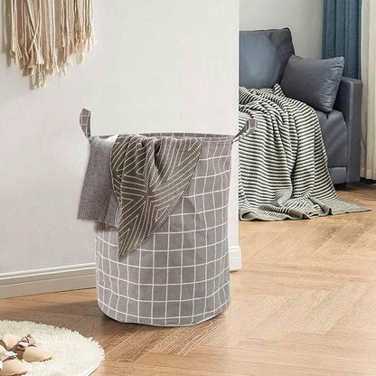 Panier à linge pliable gris en coton, idéal pour la buanderie.