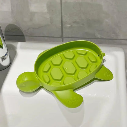 Porte-savon tortue pour enfant dans la douche, accessoire amusant et antidérapant pour ranger le savon en toute sécurité.